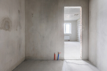 interior of the apartment without decoration in gray colors. rough finish