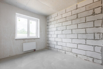 Fototapeta premium interior of the apartment without decoration in gray colors. rough finish