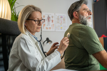 the doctor listens to the patient's lungs and heartbeat - Powered by Adobe