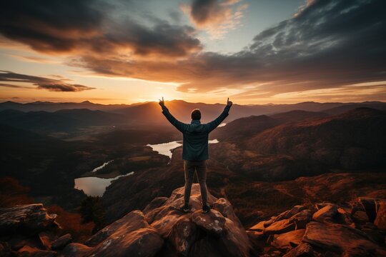 Hikers enjoying golden hour landscape view over the mountains.