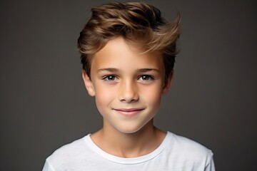 Portrait of a cute young boy with blond hair. Studio shot.