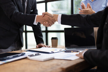 Businessmen shaking hands at a meeting of business partners.