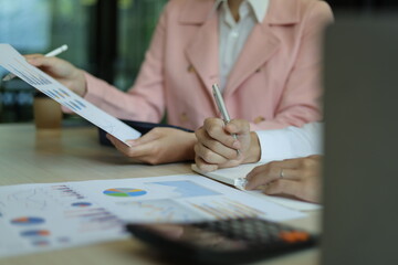 Colleagues working on paperwork in the office. Businessperson discussing the analysis of financial and accounting business reports.