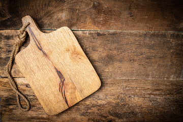 Old wooden kitchen utensils or cooking tools and bowls on wooden background, top view, flat lay....