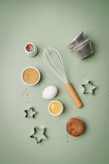 Baking or cooking colorful background. Ingredients, kitchen items for baking. Kitchen utensils, flour, eggs, sugar and muffins. Text space, top view.