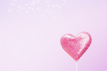 Simple single glittery pink balloon for Valentine's Day or birthday on pink background.