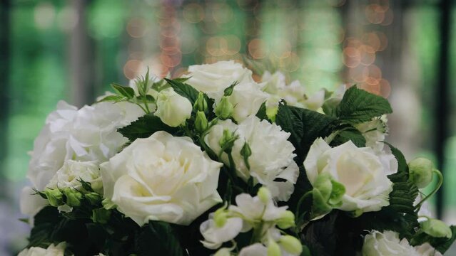 Beautiful close-up of a bouquet of flowers. A juicy side is visible behind the bouquet. The camera moves smoothly while shooting
