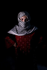 plastanina woman wearing traditional clothes with white keffiyeh on dark background