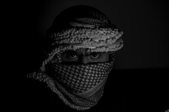 bearded jordanian male wearing keffiyeh with dark background