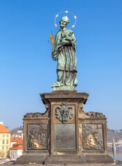 Fototapeta na wymiar Statue of John of Nepomuk on the Charles bridge in Prague.
