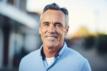 Portrait of handsome mature man in casual clothes looking at camera outdoors