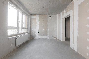 interior of the apartment without decoration in gray colors. rough finish
