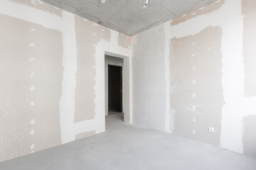 interior of the apartment without decoration in gray colors. rough finish