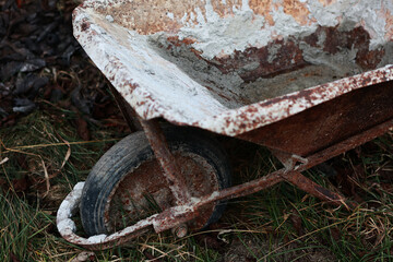 Old metal wheelbarrow for construction.