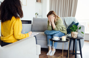  Female African American psychotherapist offering female middle age client