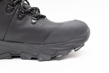 Black winter boots with tread on the sole on a white background