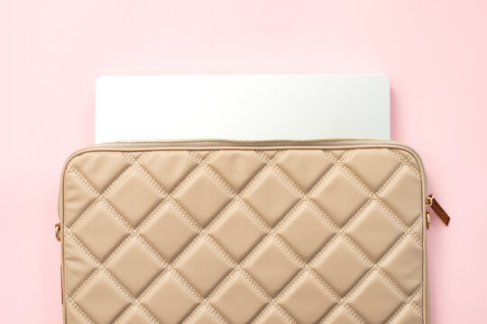 Laptop bag with laptop on pink background