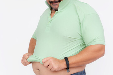 An overweight man struggles to cover his belly with a tight polo shirt that used to fit him. A...