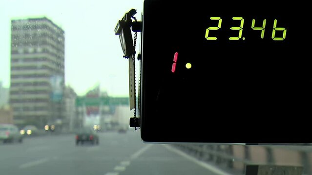 Taximeter or Auto Fare Meter inside an Argentine Taxi While Driving on Freeway in Buenos Aires, Argentina. Close Up.