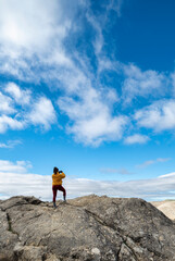 Girl captures the beauty of the Sierra de las Nieves with her cell phone, standing on prominent...