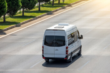 Passenger white minibus accelerating ride on highway - obrazy, fototapety, plakaty