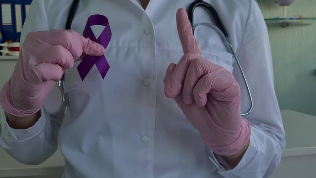 Purple ribbon awareness in doctor hand for ADD and ADHD cancer