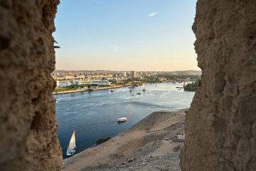 Sunset over the Nile River in the city of Aswan with sandy and deserted shores