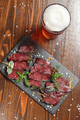 Roast beef, glass of beer, dark and moody, top new