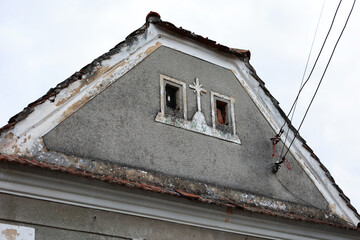 Old house with a cross on the wall.