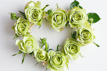 Top-View Of A Heart-Shaped Arrangement Of Green Roses On A White Background