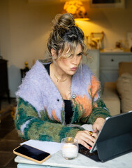 Portrait of young woman teleworking very concentrated at home, vertical photo
