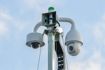  Two security cctv dome camera's  for construction site on a blue sky background  with green signal...