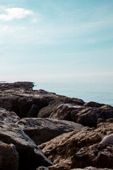 Stone rocky shore against the backdrop of the sea ocean. Summer mood