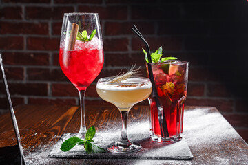Cocktails with ice and fruits on a dark background. Selective focus.