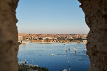 Sunset over the Nile River in the city of Aswan with sandy and deserted shores