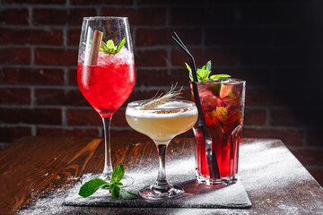 Cocktails with ice and fruits on a dark background. Selective focus.