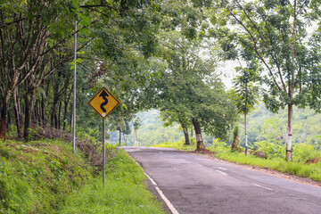 sign on the road, winding road signs