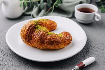 Pistachio Croissant on plate with Tea
