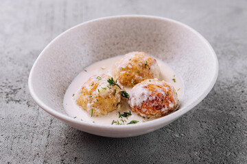Creamy sauce fried meatballs on plate