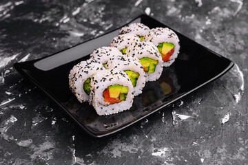 Delicious avocado sushi roll with salmon