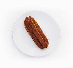 delicious chocolate French eclair on plate