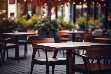 Obraz premium Empty table in an outdoor cafe on a city street, showing elegant wooden furniture and vintage atmosphere.