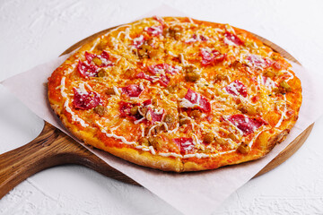 Pepperoni pizza with sausage on wood background