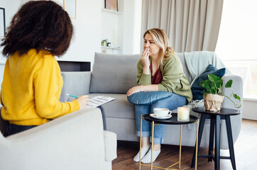  Female African American psychotherapist offering female middle age client