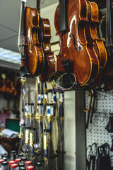 there are many violins hanging from the ceiling at a store
