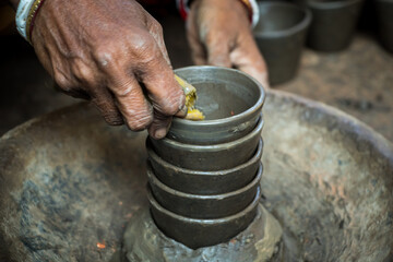Pottery making involves shaping clay by hand, using a wheel, or coiling techniques.