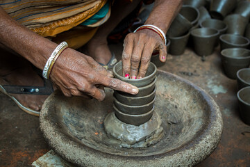 Pottery making involves shaping clay by hand, using a wheel, or coiling techniques.