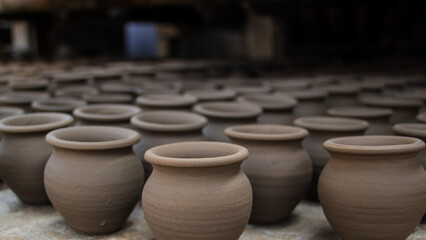 Pottery making involves shaping clay by hand, using a wheel, or coiling techniques.