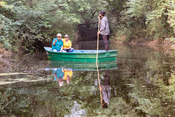 Senior couple tourist traveling on boat at lake