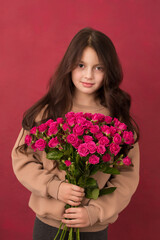 Beautiful girl with a bouquet of small pink roses